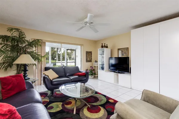 a living room with furniture and a dining table with rug