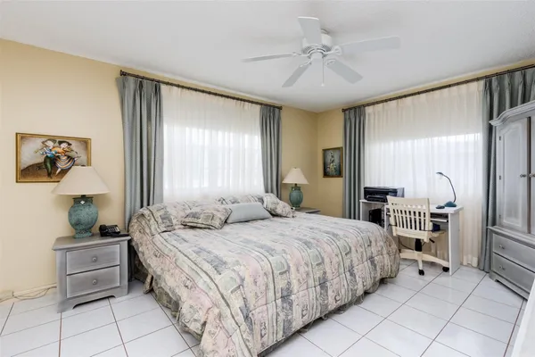 a large bedroom with a bed and a chandelier