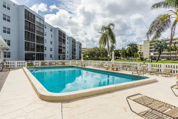 a swimming pool with an outdoor seating