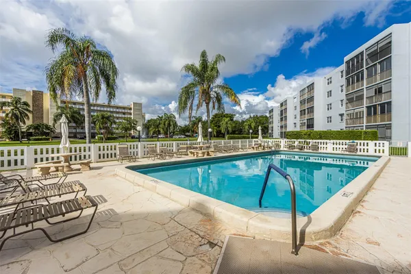 a view of swimming pool with outdoor seating and yard
