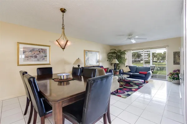 a living room with furniture a window and a dining table