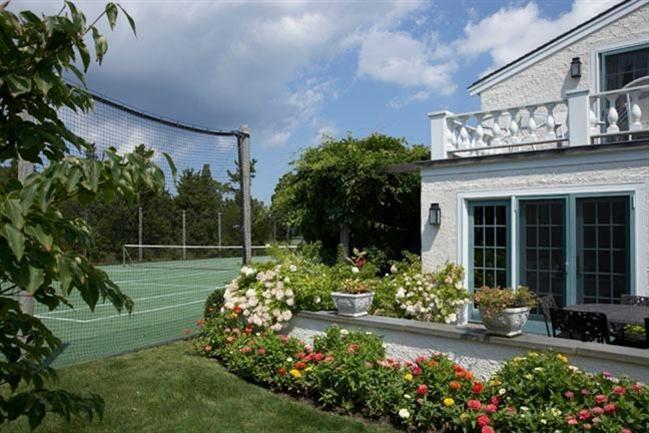 265 Seapuit Road Osterville, MA 02655 - Photo 24 of 30 a house with a flower garden in front of it