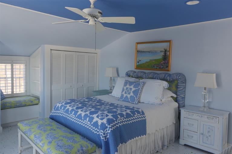 265 Seapuit Road Osterville, MA 02655 - Photo 28 of 30 a bedroom with a large bed and a chandelier