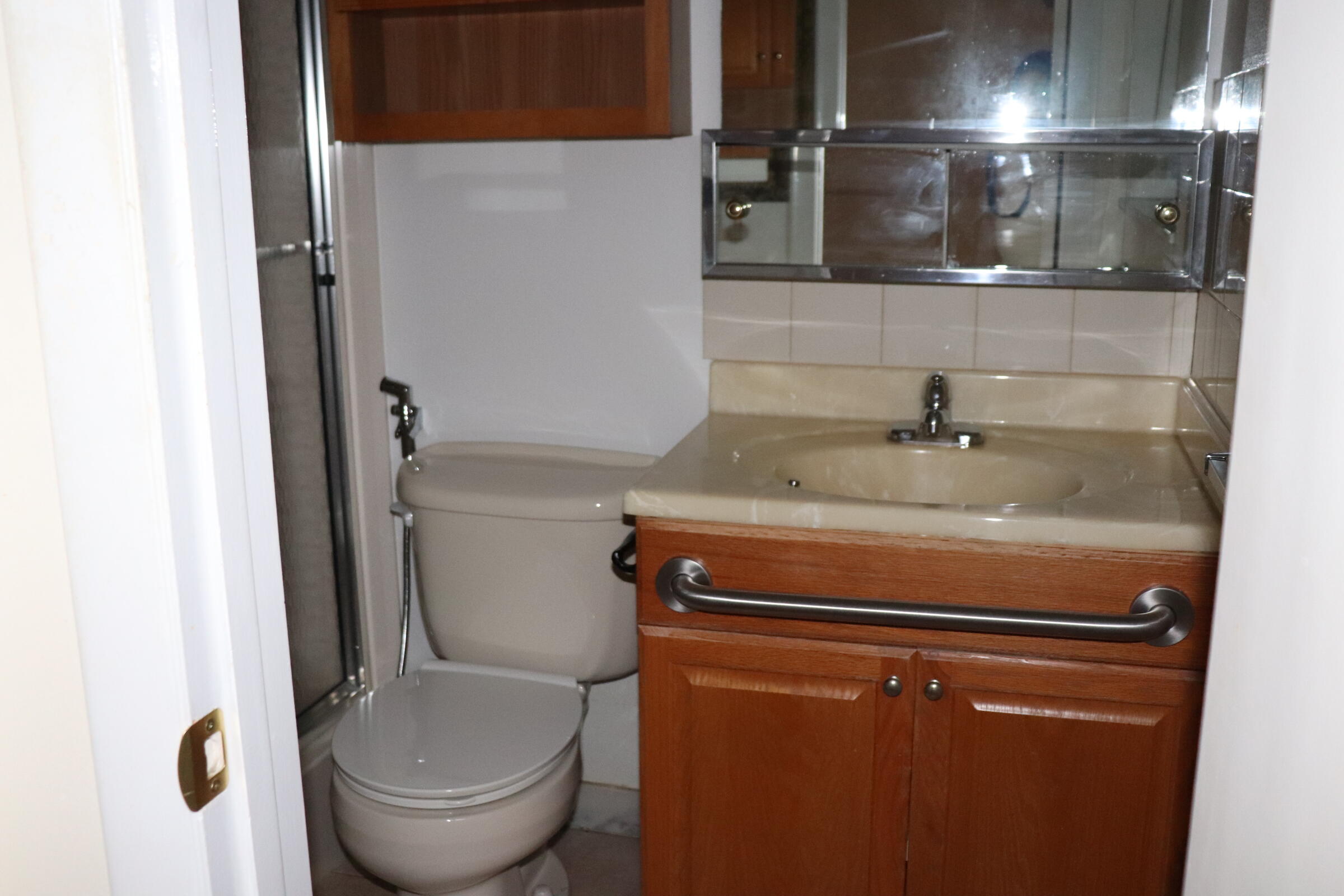 201 Cardinal Lane Delray Beach, FL 33445 - Photo 13 of 20 a bathroom with a granite countertop toilet sink and mirror