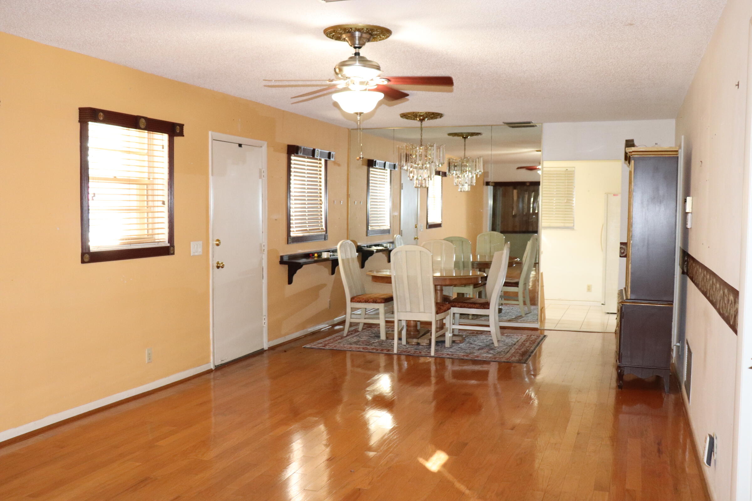 201 Cardinal Lane Delray Beach, FL 33445 - Photo 5 of 20 a view of a dining room with furniture a chandelier and wooden floor