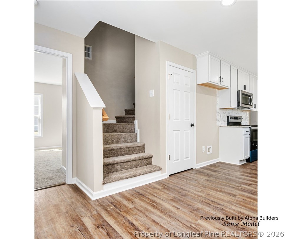 973 Martin Road St. Pauls, NC 28384 - Photo 5 of 19 Stairway leading to the upstairs bedrooms and bonus space.
