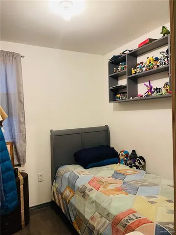 a bedroom with a bed and flat screen tv