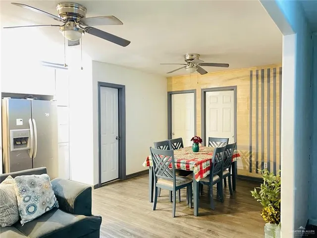 a dining room with furniture window and wooden floor