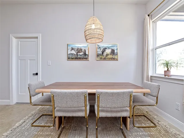 a dining room with furniture and window