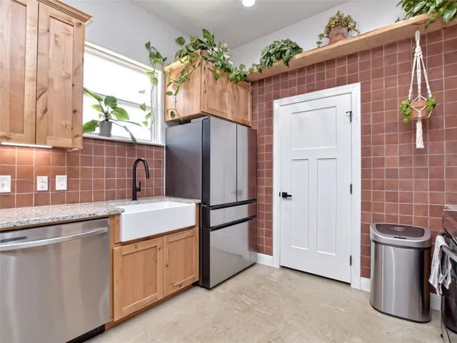 a kitchen with a sink and refrigerator