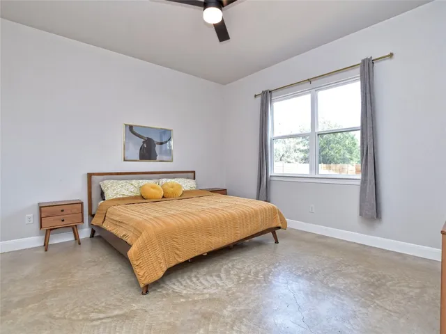 a bedroom with a bed and window
