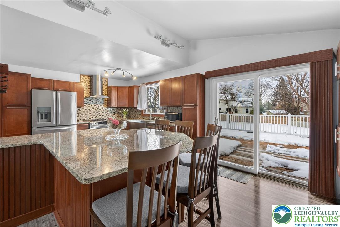 4000 Carter Road Bethlehem, PA 18020 - Photo 15 of 48 a kitchen with stainless steel appliances granite countertop a stove a refrigerator a kitchen island and chairs in it