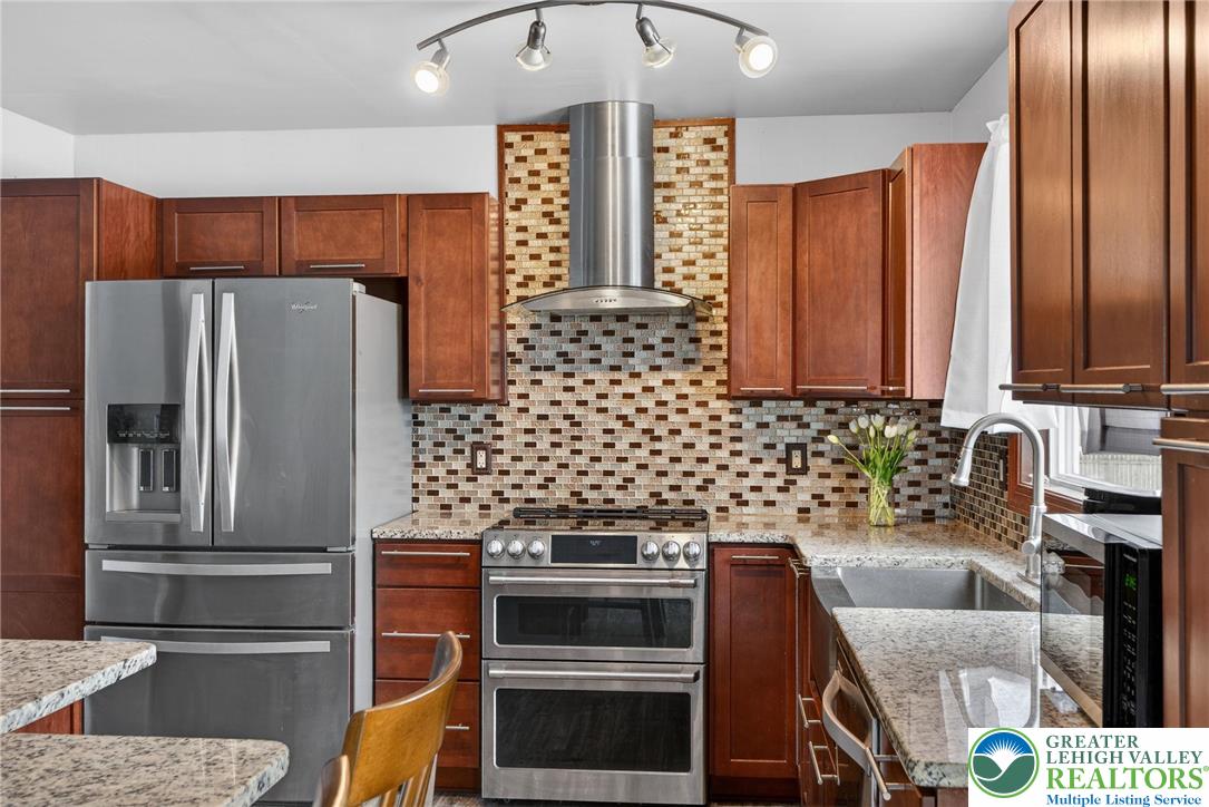 4000 Carter Road Bethlehem, PA 18020 - Photo 18 of 48 a kitchen with stainless steel appliances kitchen island granite countertop a refrigerator and a stove top oven