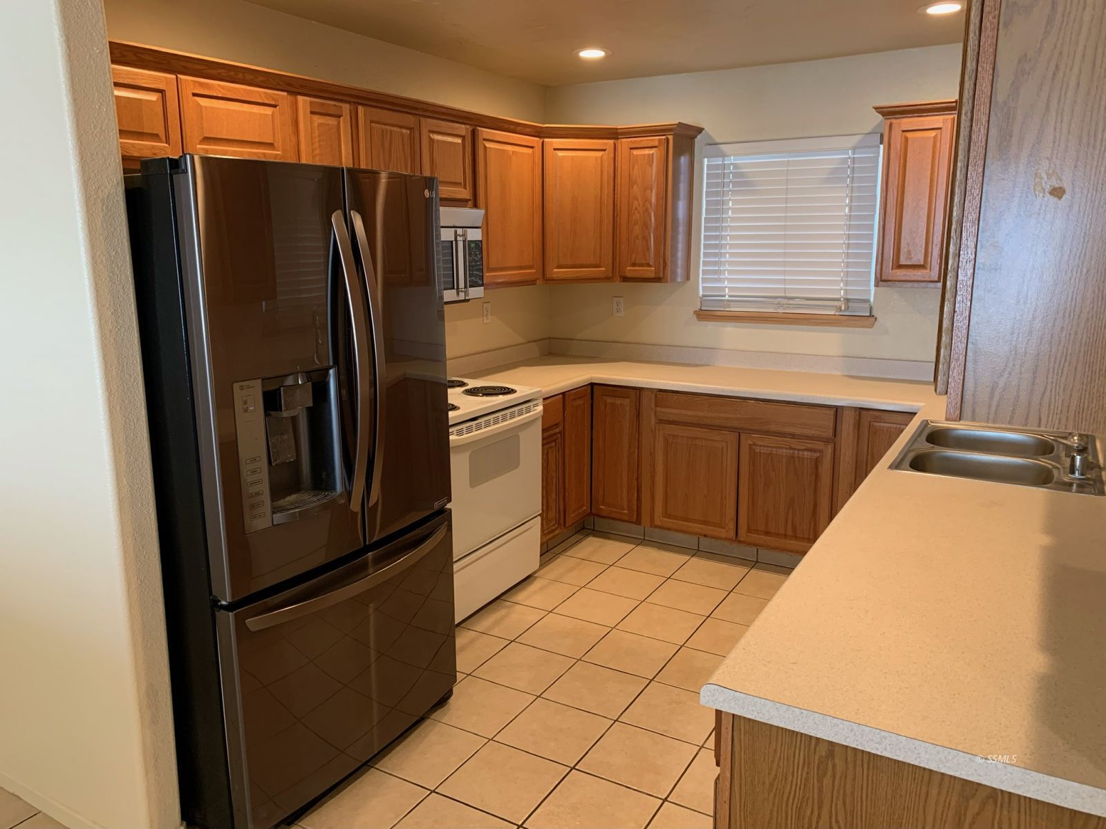 1640 South Mahan Street Ridgecrest, CA 93555 - Photo 6 of 27 a kitchen with stainless steel appliances granite countertop a refrigerator and a sink