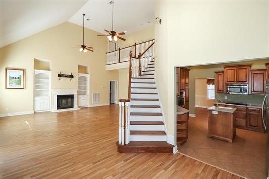 5982 Purple Road Byron, GA 31008 - Photo 13 of 36 a view of a room with wooden floor fireplace and windows