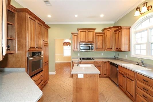 5982 Purple Road Byron, GA 31008 - Photo 14 of 36 a kitchen with stainless steel appliances a sink a stove a refrigerator cabinets and a window