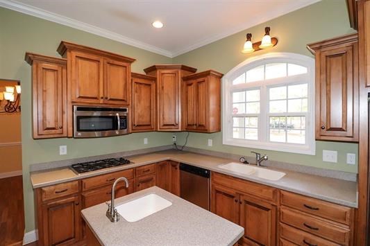 5982 Purple Road Byron, GA 31008 - Photo 15 of 36 a kitchen with stainless steel appliances a sink cabinets and a window
