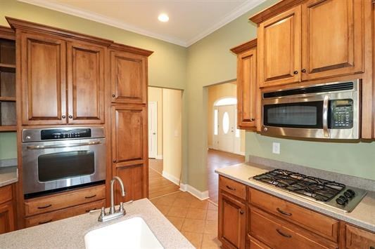 5982 Purple Road Byron, GA 31008 - Photo 16 of 36 a kitchen with granite countertop cabinets stainless steel appliances and a window