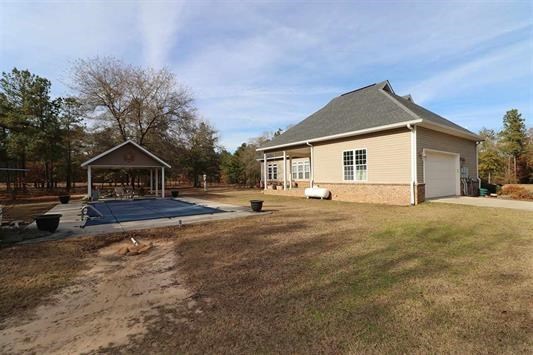 5982 Purple Road Byron, GA 31008 - Photo 36 of 36 a house view with wooden fence and a trees