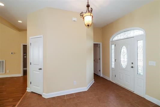 5982 Purple Road Byron, GA 31008 - Photo 5 of 36 an empty room with wooden floor and mirror