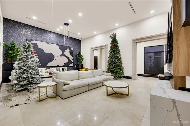 a living room with furniture and flowers