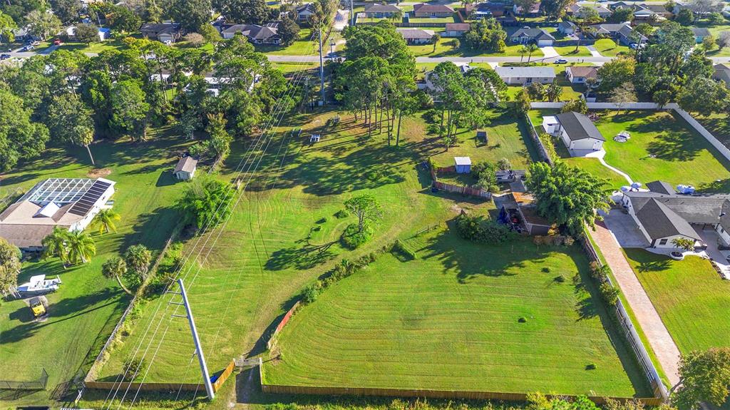 1679 Pinedale Road Edgewater, FL 32132 - Photo 16 of 24 a view of an swimming pool with a yard and plants