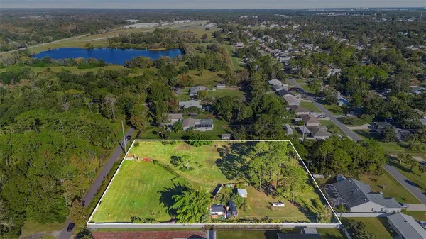 an aerial view of a houses with swimming pool