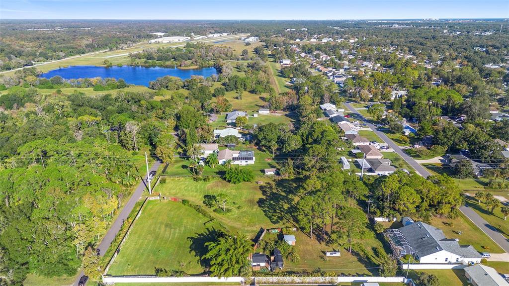 1679 Pinedale Road Edgewater, FL 32132 - Photo 5 of 24 an aerial view of residential houses with outdoor space and trees