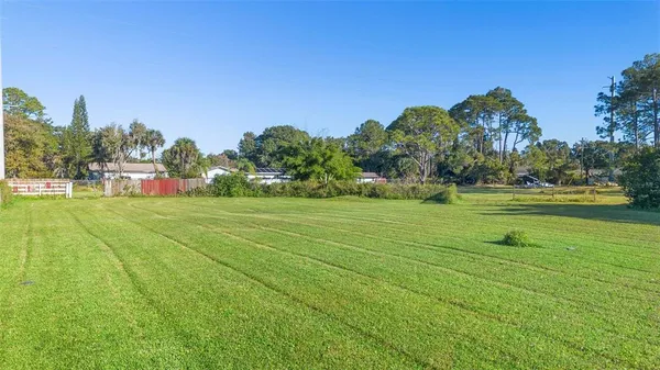 a view of a golf course with parking space