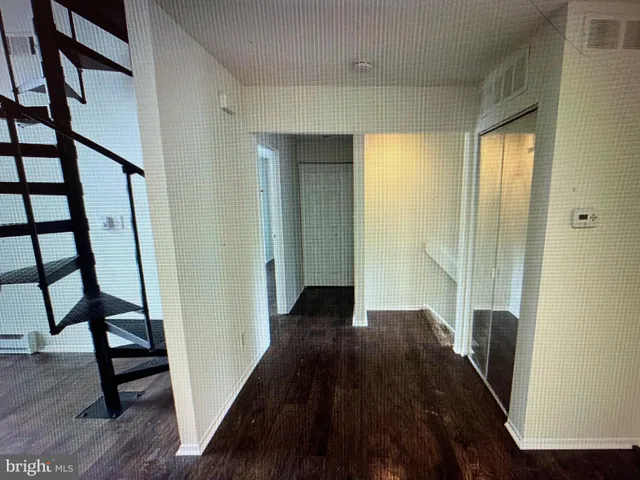 a view of a hallway view with wooden floor and staircase