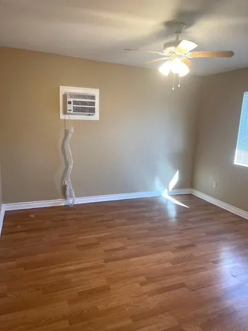 a view of a room with wooden floor and window