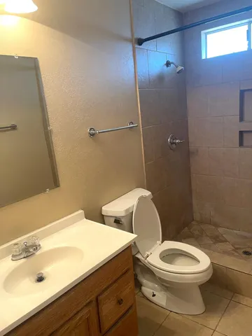 a white toilet sitting next to a bathroom sink