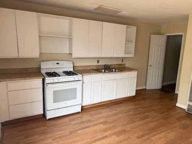 a kitchen with stainless steel appliances a stove top oven and cabinets