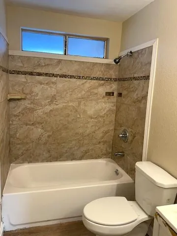 a bathroom with a toilet and a bathtub
