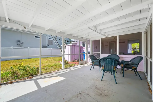 a view of a porch with furniture and a yard