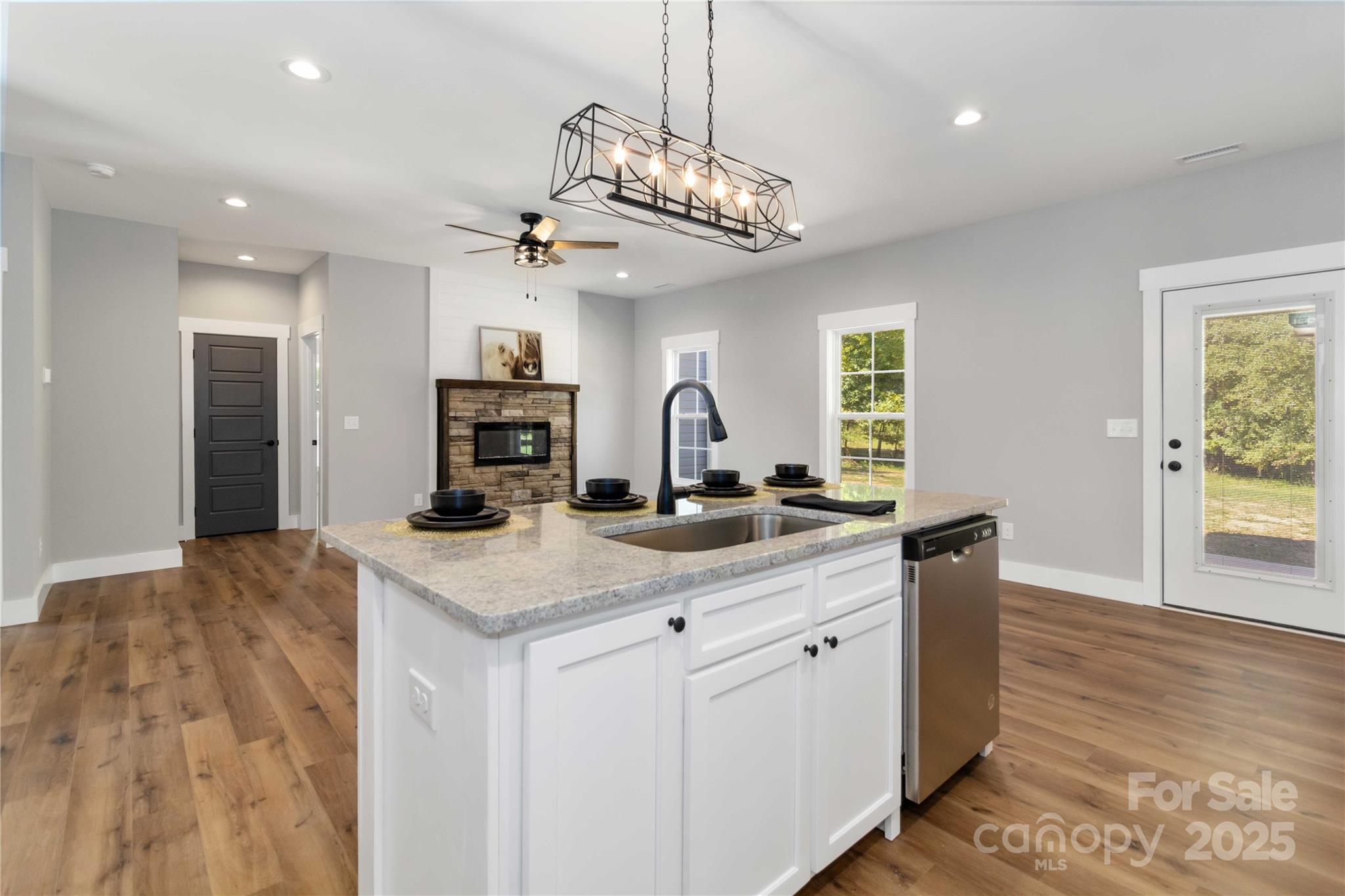 2605 Mt Prospect Road Chester, SC 29706 - Photo 15 of 31 a kitchen with kitchen island granite countertop a sink cabinets and wooden floor