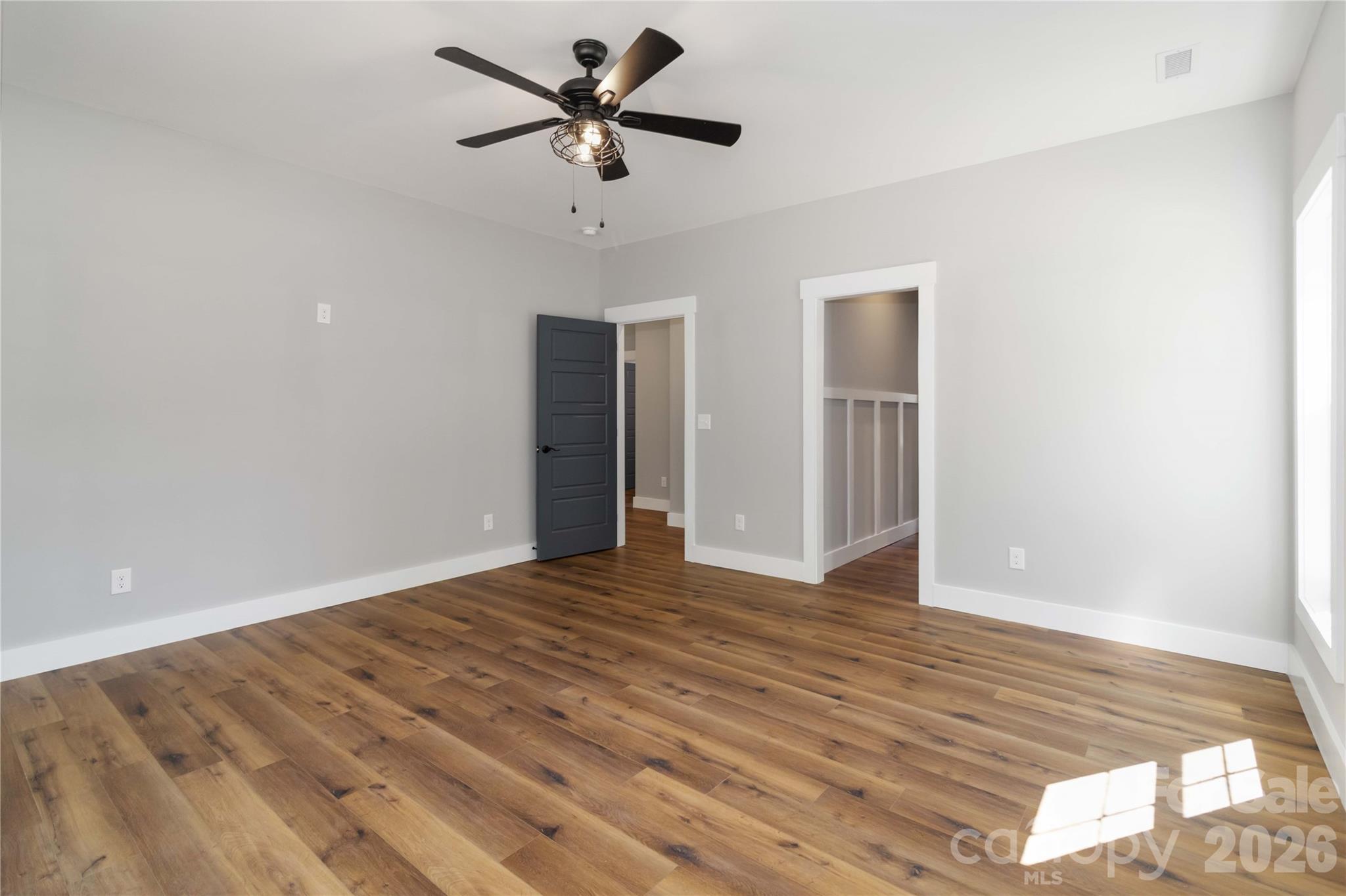 2605 Mt Prospect Road Chester, SC 29706 - Photo 17 of 31 an empty room with wooden floor and ceiling fan
