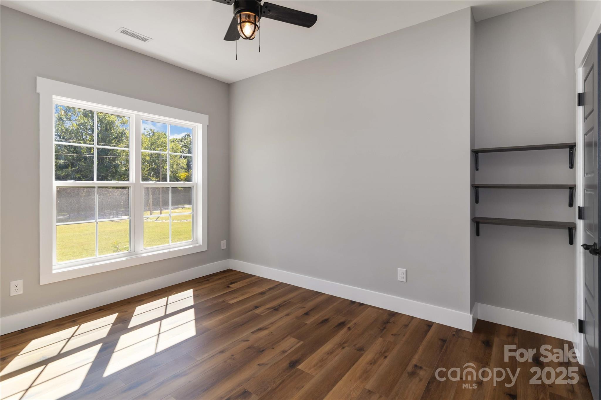 2605 Mt Prospect Road Chester, SC 29706 - Photo 21 of 31 a view of an empty room with a window and wooden floor