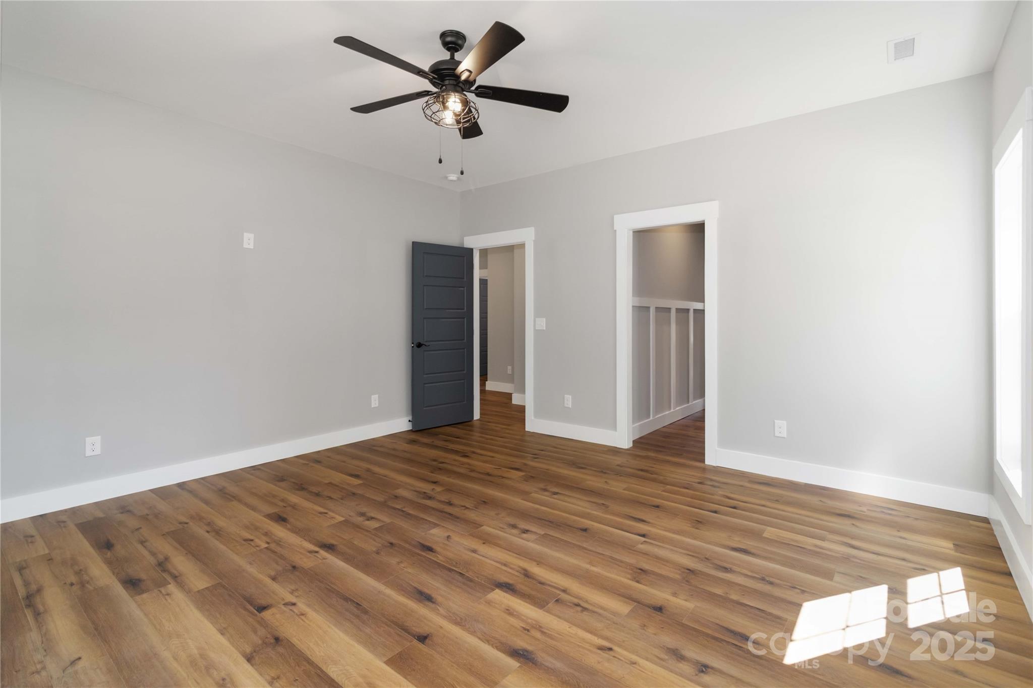 2605 Mt Prospect Road Chester, SC 29706 - Photo 23 of 31 an empty room with wooden floor and ceiling fan