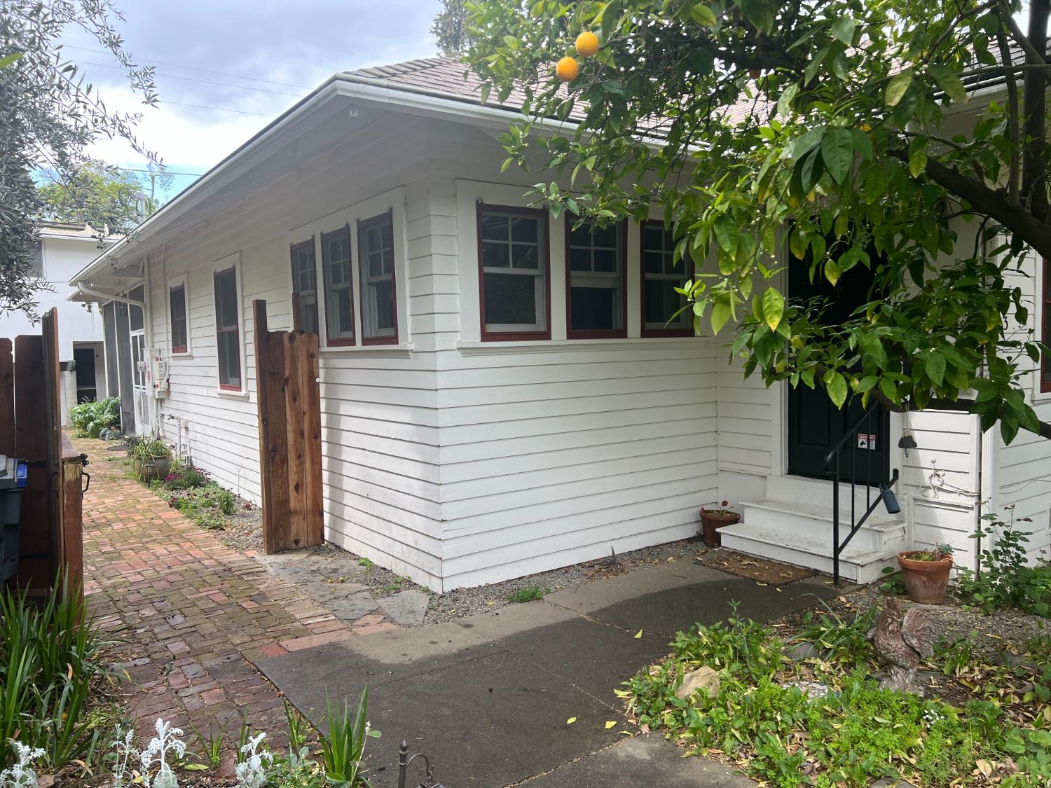 a small yard with a table and chair in the patio