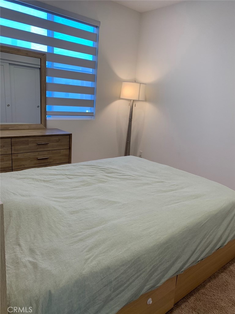 203 Novel Irvine, CA 92618 - Photo 17 of 24 a bedroom with a bed and a night stand