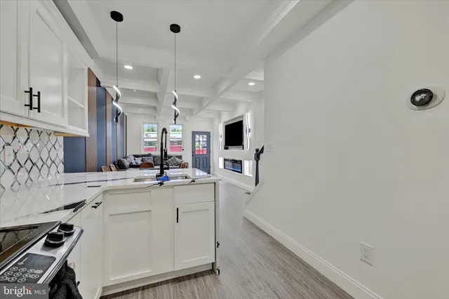 a kitchen with a sink appliances and cabinets