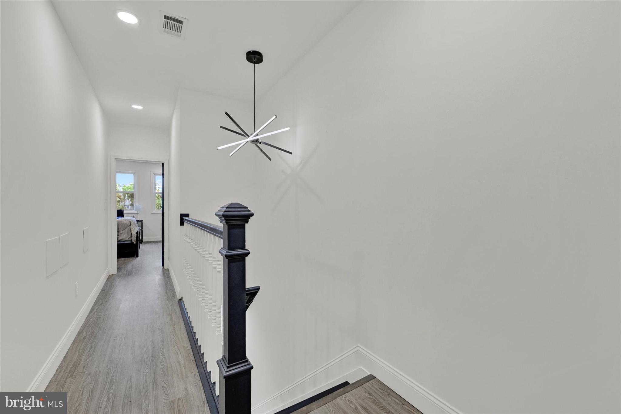 1748 North Chester Street Baltimore, MD 21213 - Photo 14 of 27 a view of a hallway with wooden floor and staircase