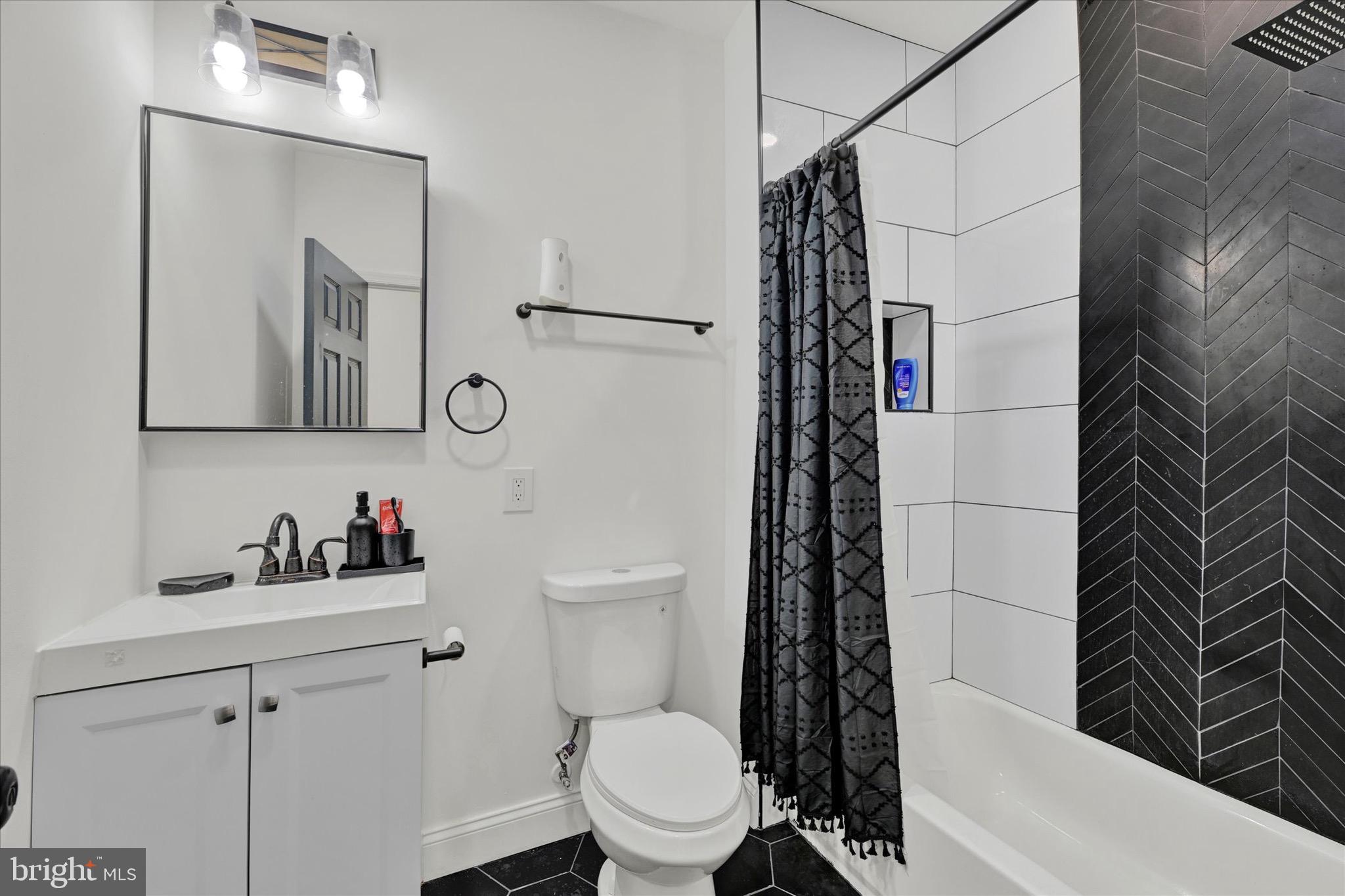 1748 North Chester Street Baltimore, MD 21213 - Photo 15 of 27 a bathroom with a toilet a sink and mirror