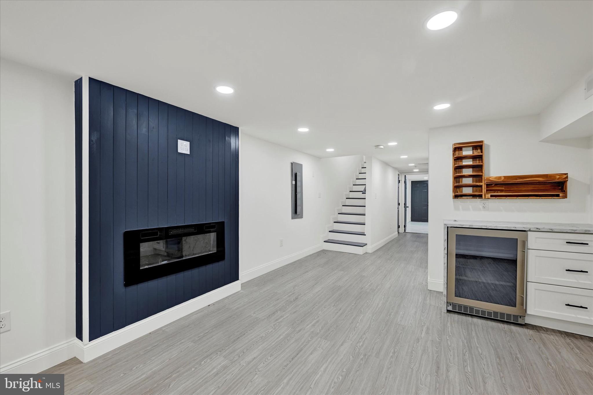 1748 North Chester Street Baltimore, MD 21213 - Photo 21 of 27 a view of an empty room with a fireplace and a kitchen view