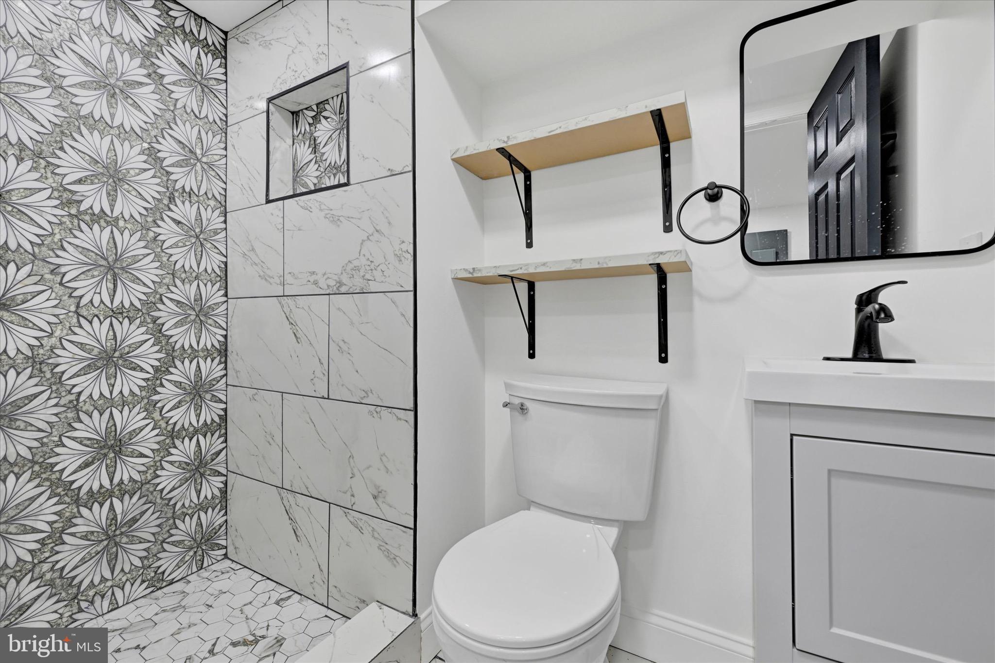 1748 North Chester Street Baltimore, MD 21213 - Photo 22 of 27 a bathroom with a toilet sink and mirror