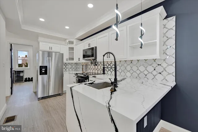 a kitchen with stainless steel appliances a refrigerator sink and cabinets