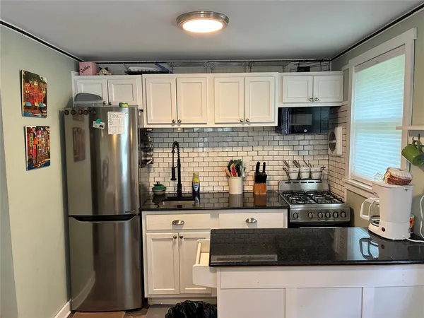 a kitchen with stainless steel appliances a refrigerator sink and cabinets