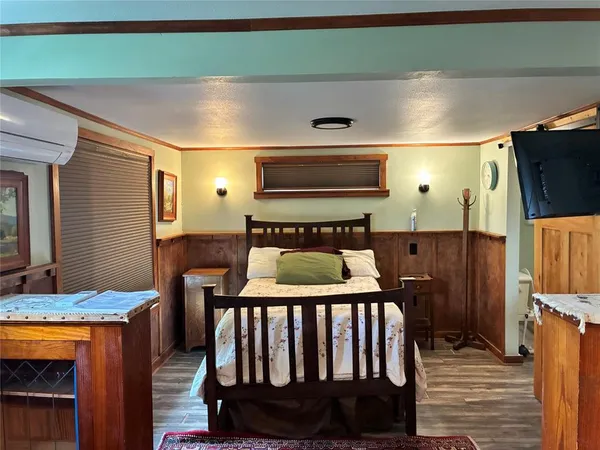 a bedroom with furniture and a window