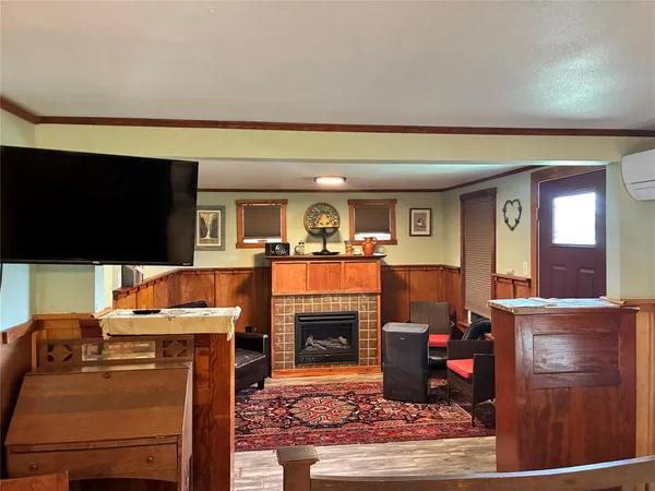 a living room with furniture a fireplace and a flat screen tv